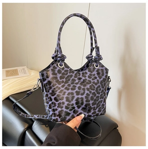 Detail of purple leopard print handbag with glossy PU leather and round handles