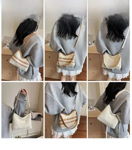 Detailed views of striped and white knit crossbody bags with crescent shape on a model