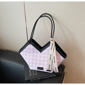 Detail of purple checkered tote bag with V-cut opening and elegant decorative ribbon