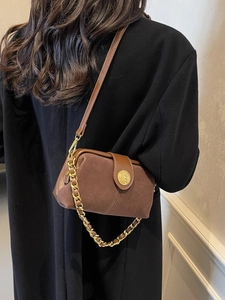 Brown vintage suede crossbody bag with gold chain strap and leather trim detail