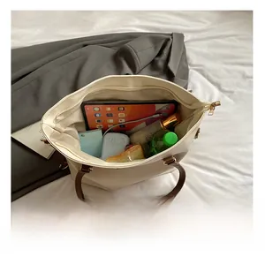 Spacious interior of beige tote bag showing large capacity for tablet and daily items