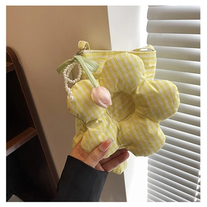 Detail of yellow striped flower handbag with pearl handle and tulip charm accessory