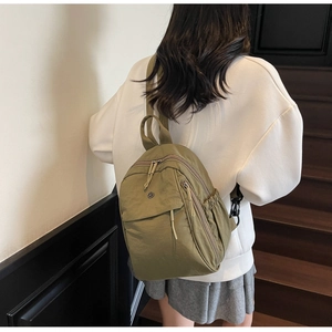 Olive green casual nylon backpack shown from behind to display size and back straps detail