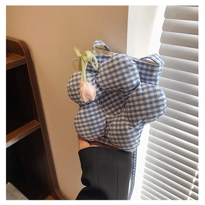 Detail view of blue checkered flower-shaped canvas bucket bag with a tulip charm