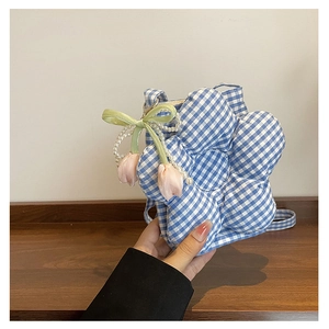 Detail of blue plaid flower-shaped bucket bag with tulip charms and pearl strap