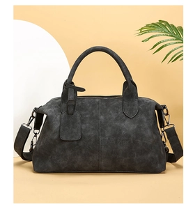 Front view of grey retro boston handbag with dual handles and detachable wide strap
