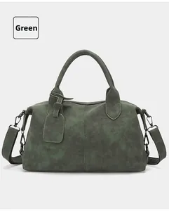Detailed macro view of vintage green boston bag with matte texture and gunmetal hardware