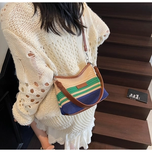 Three-color knitted hobo bag with leather strap shown on model over white knitwear