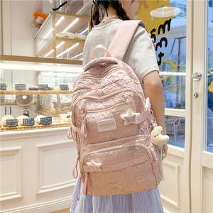 Pink quilted backpack with butterfly embroidery and cute star plush pendant detail