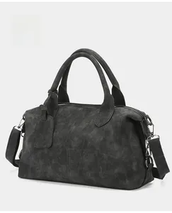 Detail shot of vintage dark grey suede Boston bag with double handles and strap