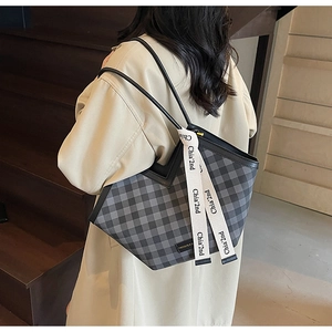 Detailed view of grey plaid tote bag with V-shaped opening and decorative ribbon strap