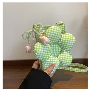 Detail of flower-shaped green gingham crossbody bag with pearl and tulip charms