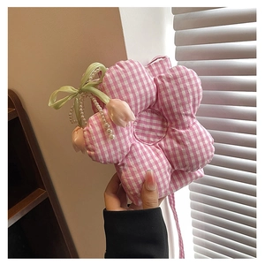 Detail of flower-shaped pink plaid canvas bag featuring pearl tulip and green ribbon charms