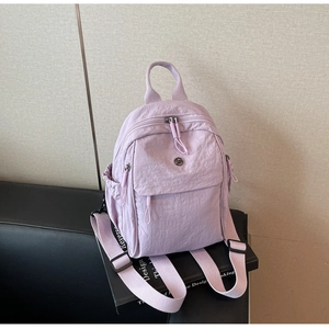 Detail view of the lavender waterproof nylon mini backpack with adjustable straps