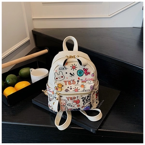 Détail d'un mini sac à dos blanc avec des motifs de graffiti colorés et des fermetures