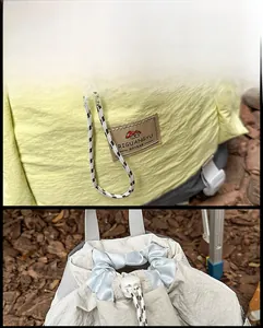 Detail of a drawstring backpack with water-resistant nylon and a leather brand patch