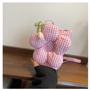 Detail of flower-shaped plaid canvas bag with pearl tulip charm and green bow ribbon