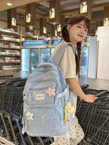Quilted light blue backpack with sequin bow embroidery and star patch for students