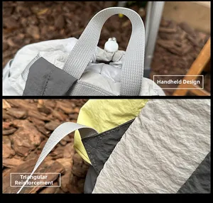 Detail of the reinforced triangular stitching and durable top handle on a nylon backpack