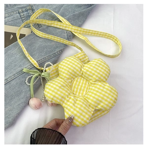 Detail of yellow checkered flower crossbody bag with pearl tulip charm and green bow