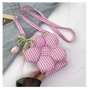 Detailed view of flower-shaped pink checkered bucket bag with tulip pearl pendants