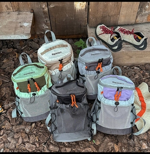 Detail of outdoor backpacks in multiple colors with mesh pockets and drawstring accents