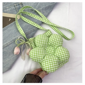 Detail of flower-shaped checkered canvas bag with pink tulip and pearl pendant charm
