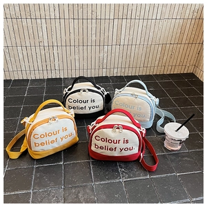 Colorful canvas bowling bags in red, yellow, blue, and black shown in a lifestyle setting