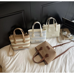 Detailed view of woven handbags in various patterns with leather handles and straps