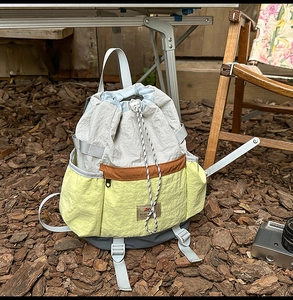 Close-up of lightweight drawstring backpack detail with contrast logo and hiking gear
