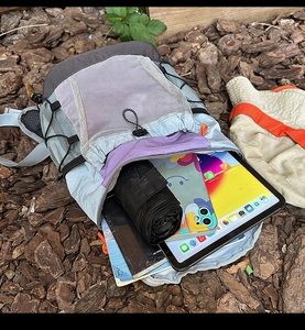 Detail of outdoor backpack interior showing storage space for tablet and umbrella