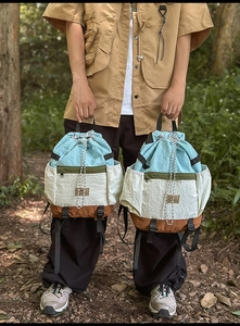 Detail of multi-color drawstring backpack with nylon fabric and reinforced straps in forest
