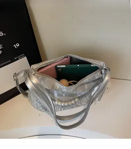 Interior view of large silver tote bag showing spacious capacity for tablets and phones