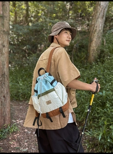 Close-up of lightweight tricolor drawstring backpack with outdoor hiking gear details