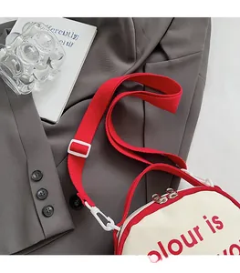 Detail of contrast stitching red canvas straps and metal zipper on the campus backpack