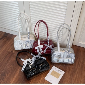 Detailed set of glossy patent leather shoulder bags in white, burgundy, silver, and black
