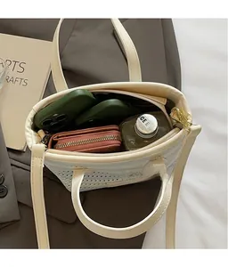 Detailed interior of woven beige tote bag showing large capacity for phone and wallet