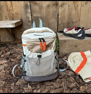 Detail of outdoor mini backpack with color-blocking design and orange zipper pulls