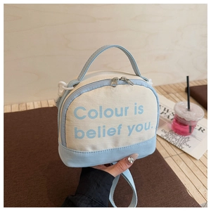 Detail view of light blue canvas bowling bag with printed text Colour is belief you