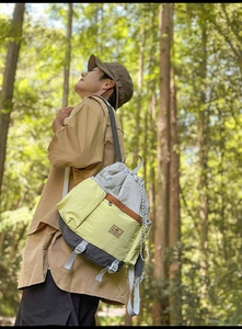Outdoor view of a high-capacity drawstring backpack with color-blocking and water-repellent nylon