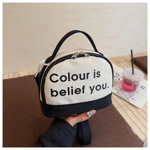 Detail of canvas bowling bag with contrasting black and white panels and artistic text