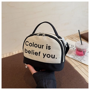 Detail of canvas mini bowling bag with black and white contrast and slogan print