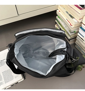 Top view of large black messenger bag with grey lining showing spacious interior space