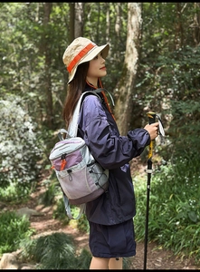 Close-up of lilac outdoor backpack with mesh pockets and professional hiking pole