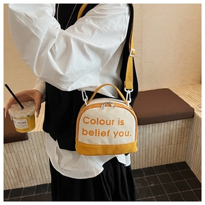 Detail of canvas bowling bag with yellow trim and slogan on the front surface
