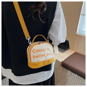 Detail showing the yellow and beige canvas bag texture with the text Colour is belief you