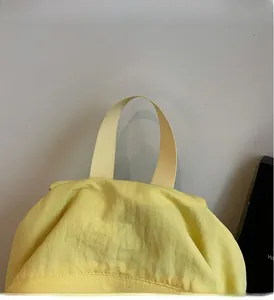 Close-up of durable reinforced yellow nylon webbing handle on canvas backpack
