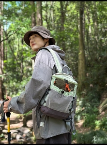 Close-up of a lightweight outdoor hiking backpack with side mesh pockets and climbing pole