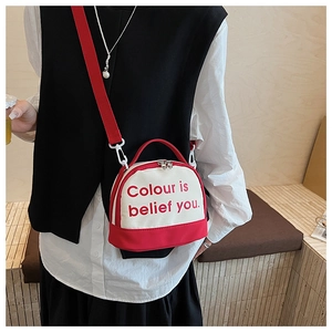 Detail of red and white canvas bowling bag with athletic strap and letter print