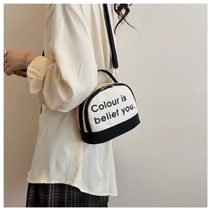 Detail of canvas bowling bag featuring contrast stitching and belief typography